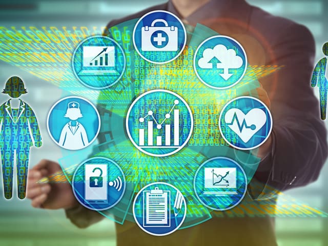 A man is touching a screen with medical icons on it